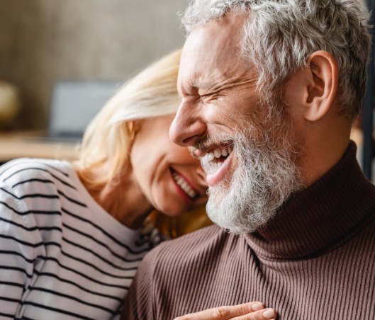 Laughing senior man and woman with dental implants in Fort Worth