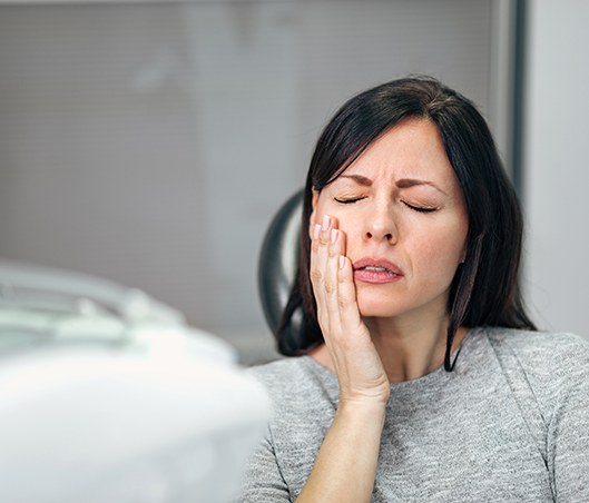 Woman with toothache in dental office visiting emergency dentist in Fort Worth, TX