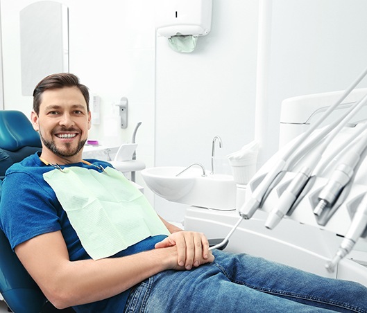 Pulled back shot of man in dental chair