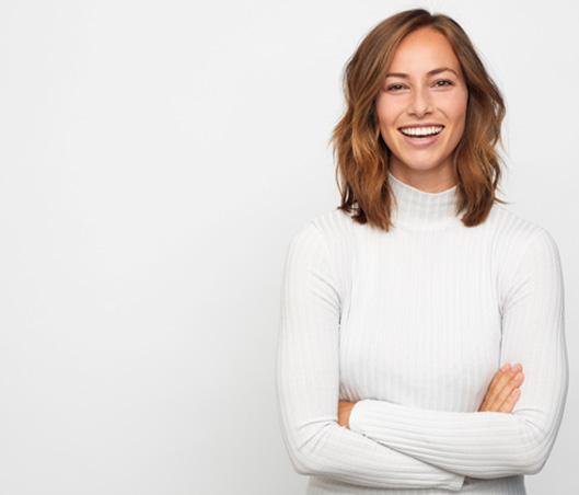 Woman smiling after teeth whitening in Fort Worth